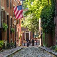Boston's photogenic, cobblestoned Acorn Street, with a flag flying