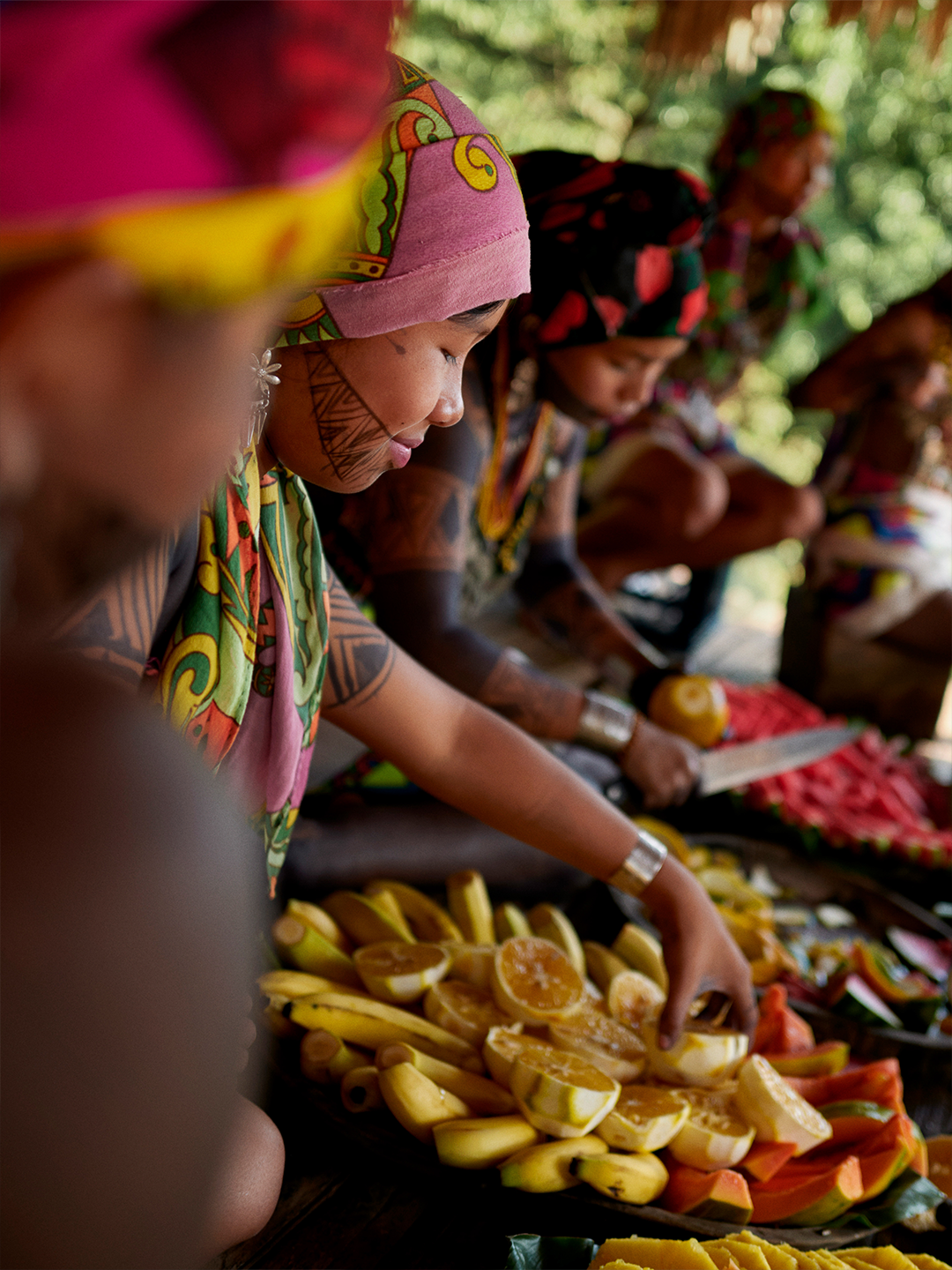 A person presents a plate of colorful food