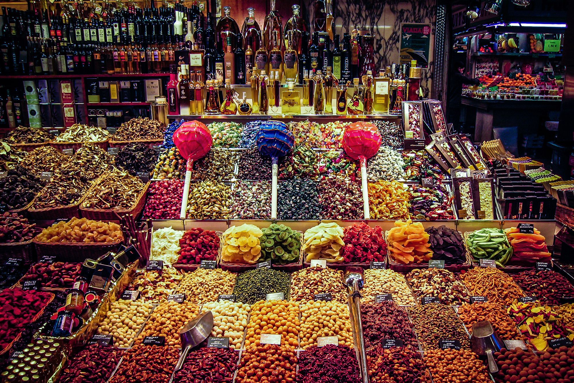 Colorful treats and snacks at a vendor booth in La Boqueria, Barcelona.