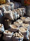 Powdery white dried yogurt balls of varying sizes in sacks, by a roadside on the way to the Pamir Mountains, Tajikistan
