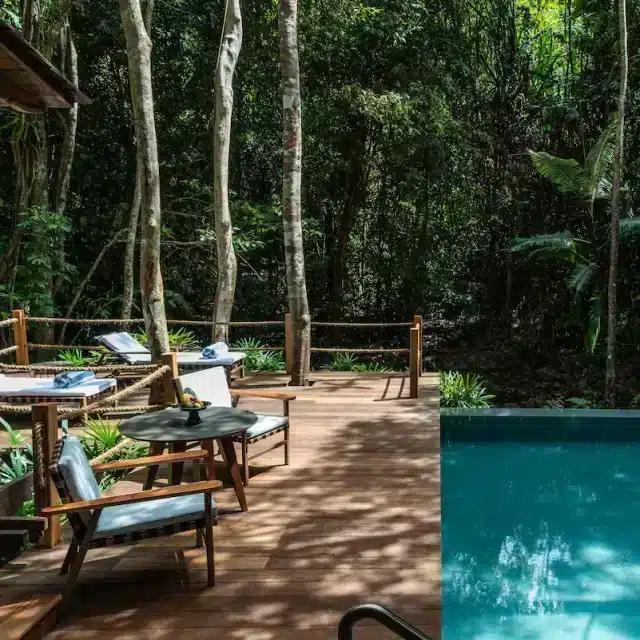 Inviting chairs sit beside a tranquil pool in the forest at the Datai Langkawi hotel, Malaysia