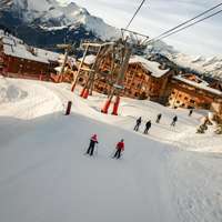 People ski beneath the Alpauris lift, nicknamed the "scare chair," in Alpe d'Huez in France