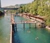 People swim and lounge on the decking at an urban lido along the river in Zürich, Switzerland