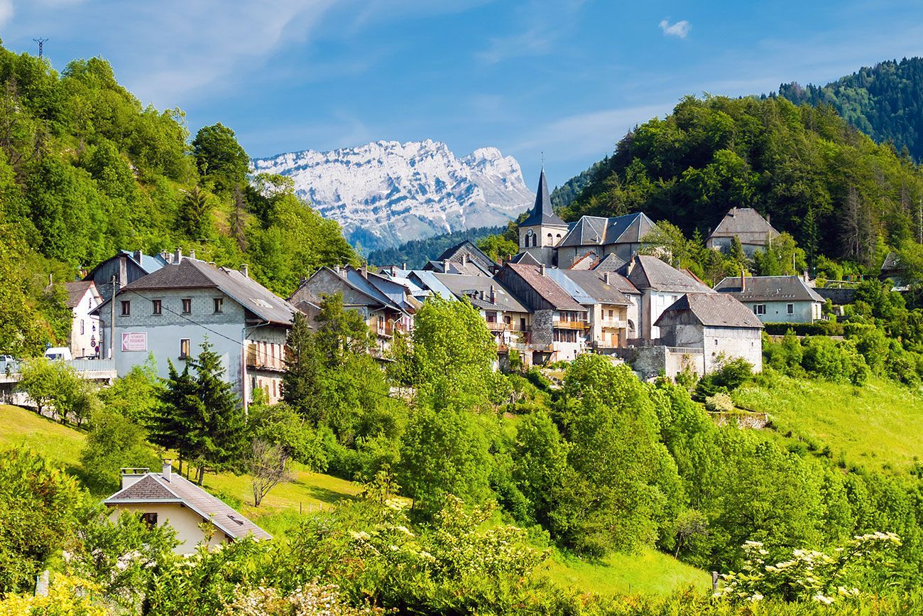 A mountain village surrounded by trees and mountains. 