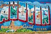 A colorful mural reading “Greetings from Austin Capitol of Texas” painted in retro postcard style on an outdoor wall with vibrant city imagery.