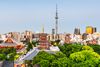 Tokyo Skytree tower in Tokyo, Japan, a tall lattice structure stretching skyward above city buildings.
