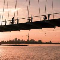 The CN Tower visible on the horizon below the Humber Bay Arch Bridge in Toronto, Canada