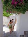 Two people wander the alleyways of Megalochori in Santorini