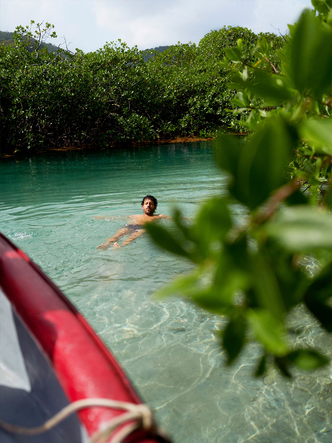 A person floats in clear blue water in Panama