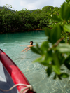 A person floats in clear blue water in Panama