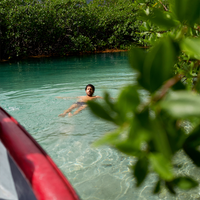 A person floats in clear blue water in Panama
