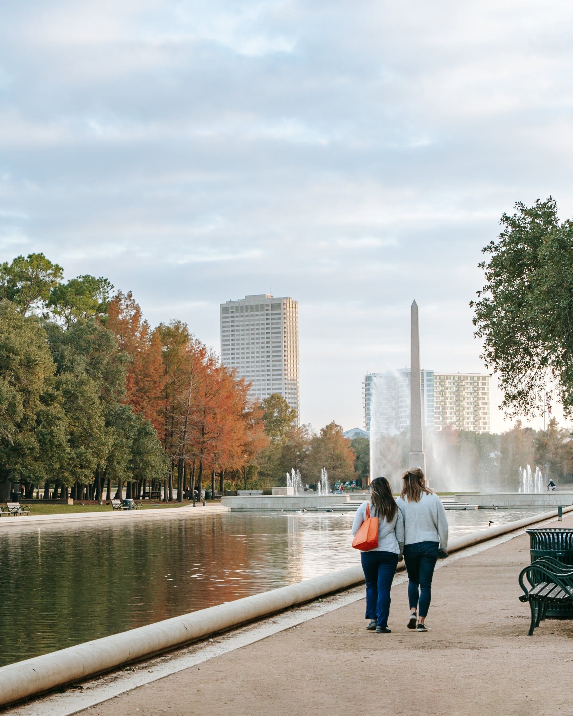 Two women walk through Hermann Park in Houston in fall