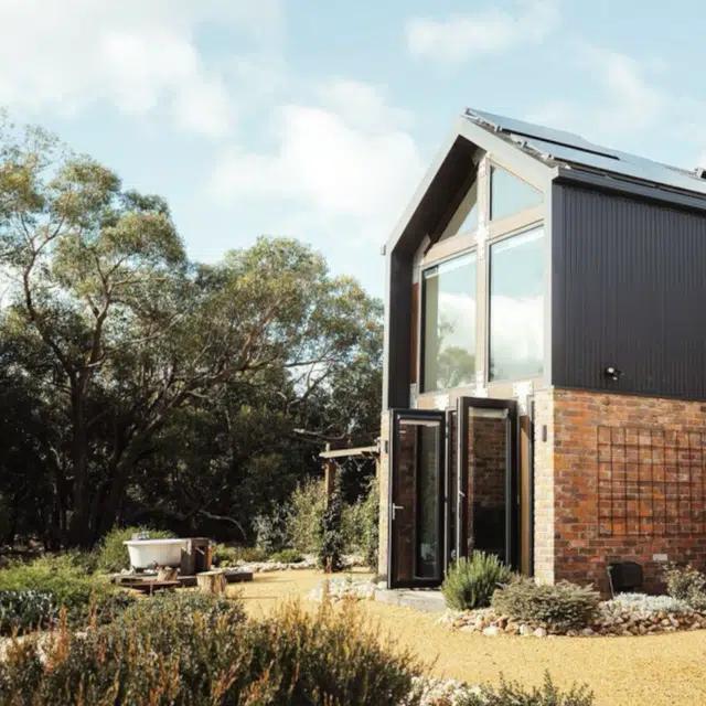 An exterior view of The Nook, a contemporary cabin in Victoria, Australia