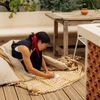 Director-producer Lily Wan sits on the deck of a Vrbo in Marseille, France, sketchign in a notebook