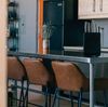 The metal kitchen island with brown leather high chairs at a Vrbo holiday rental property out in the desert in Terlingua, Texas