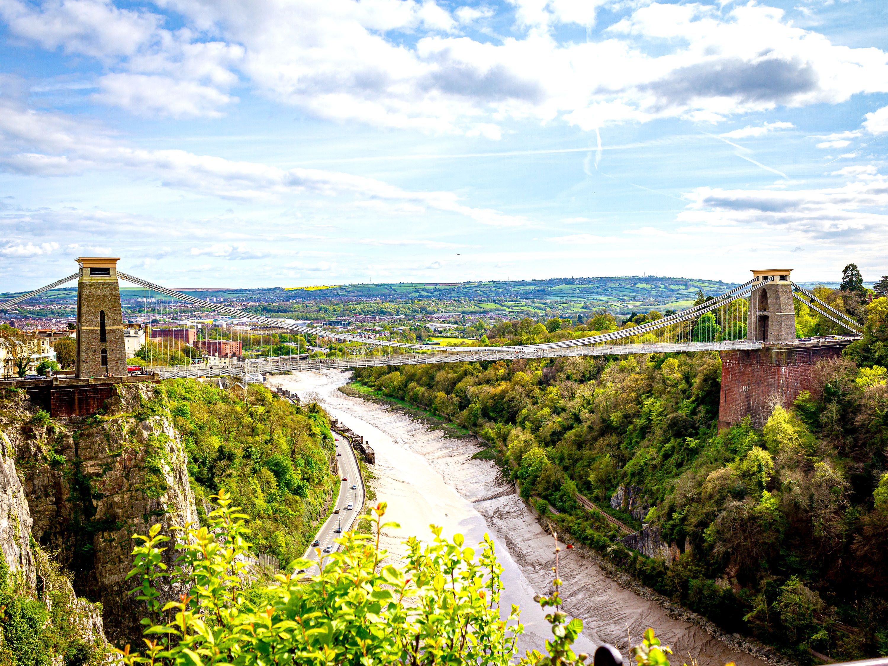 Aerial photo of suspension bridge over river. 