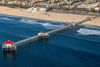 A pier with a red top extending into the ocean..