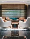 White armchairs in the sleek lobby of the Paradox Hotel in Vancouver, Canada
