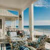 Comfy patterned furniture on a deck looking out at the Gulf Coast