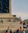 Children play at the base of Nelson's Column, Trafalgar Square, London