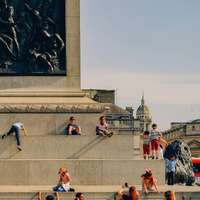 Children play at the base of Nelson's Column, Trafalgar Square, London