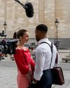 Lily Collins and Lucien Laviscount filming a scene for Emily in Paris