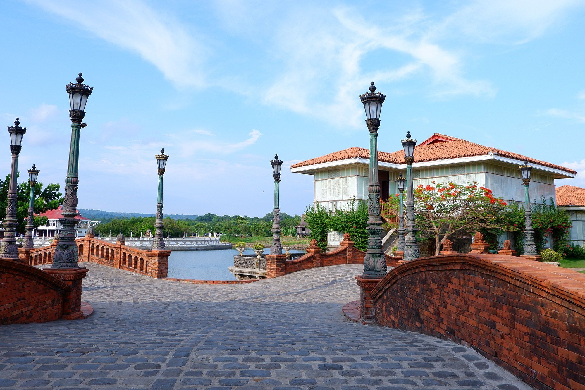 The cobblestoned streets lined with street lamps and houses in the distance in Las Casas Filipinas De Acuzar.