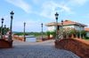 The cobblestoned streets lined with street lamps and houses in the distance in Las Casas Filipinas De Acuzar.