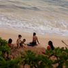 A family playing on the beach on Oahu