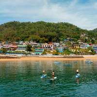 Paddleboarders in the sea off the coast of Isla Taboga, near to Panama City