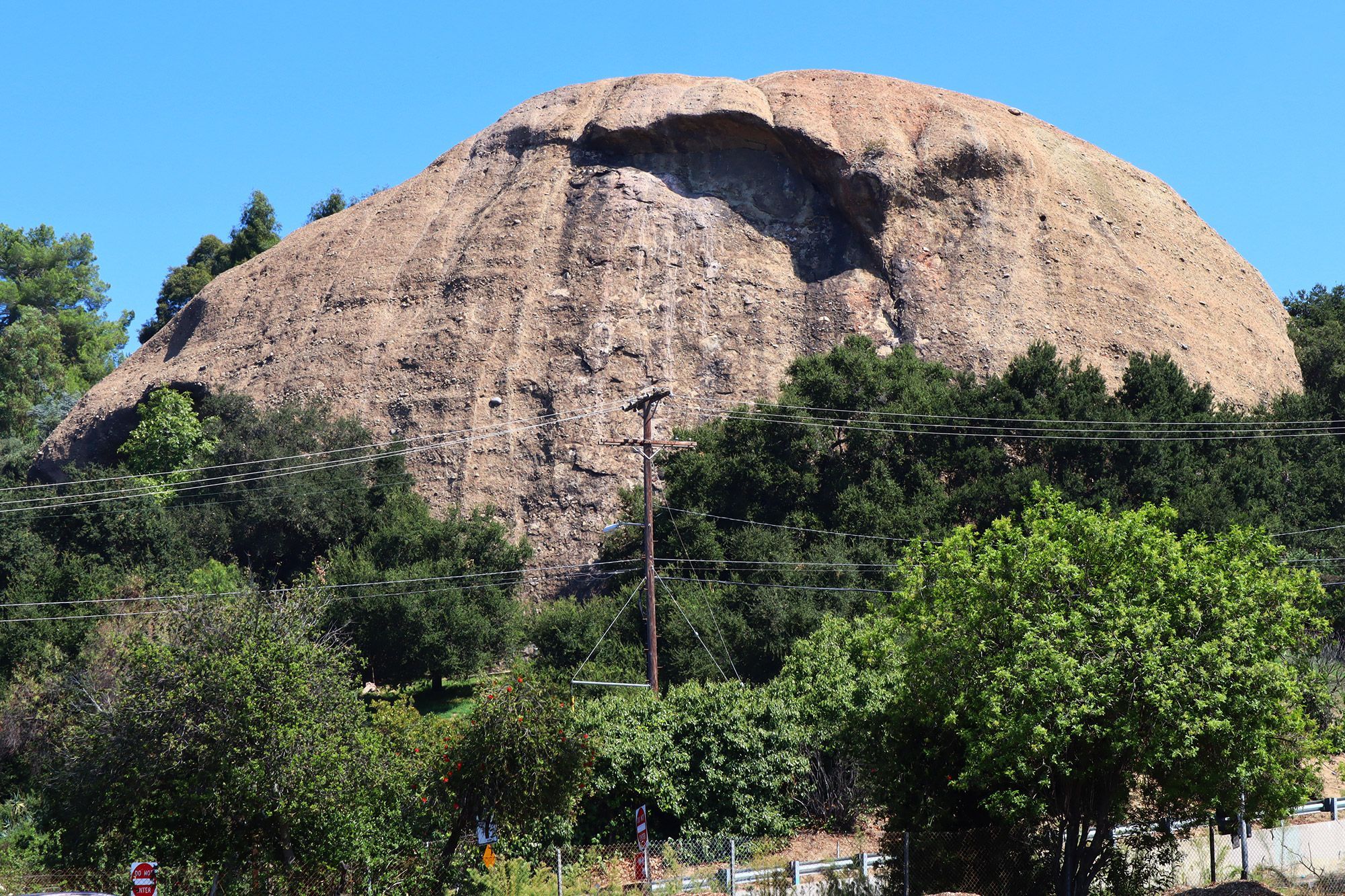 The large boulder named Eagle Rock is seen above power lines in California.
