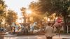 Visitors gather around a horse fountain in Old Town Scottsdale as the sun sets.