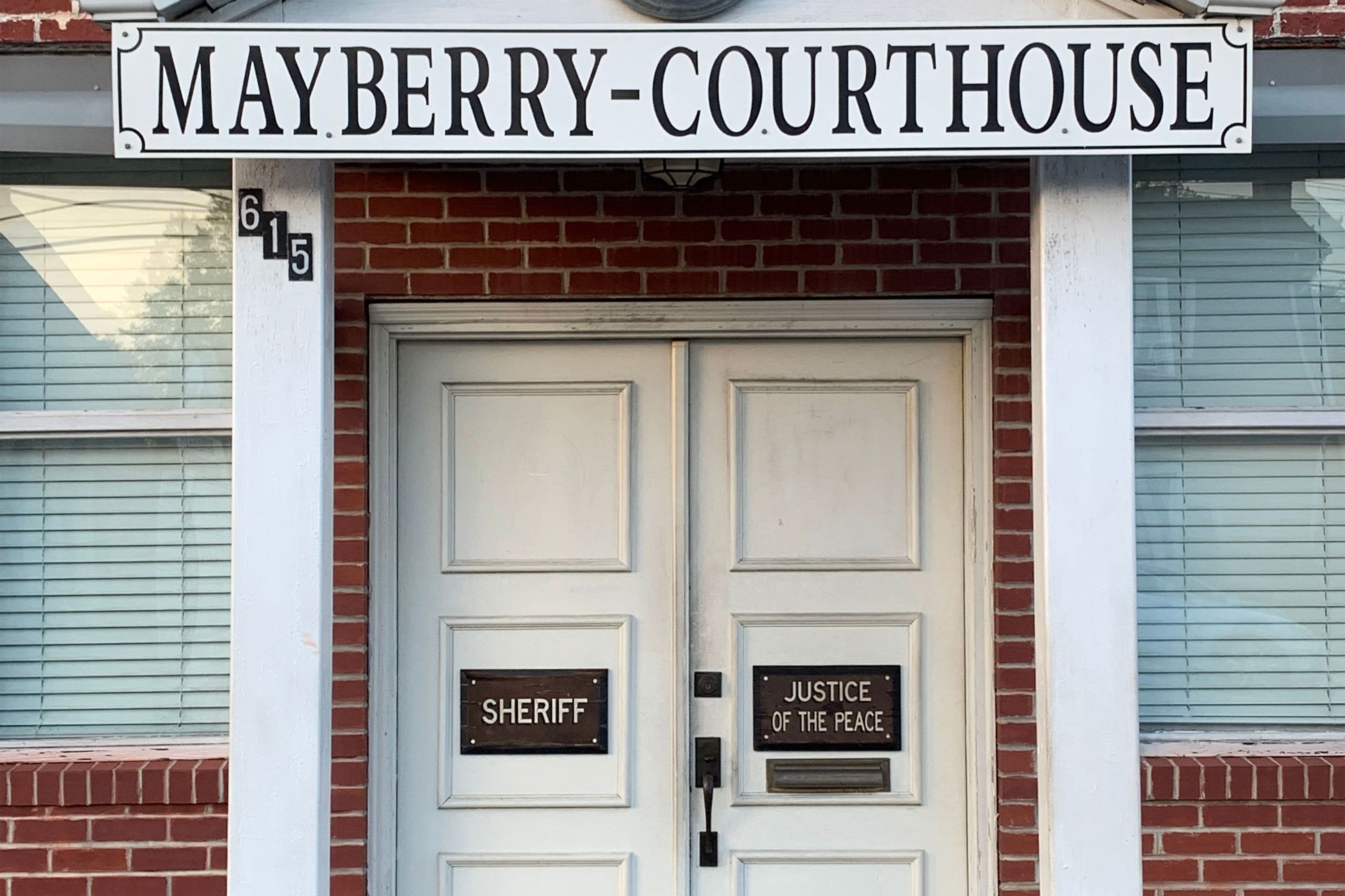The entrance to the Mayberry Courthouse with labeled sheriff and justice of the peace doors.