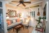 The living room, with striped sofa and wooden ceiling fan