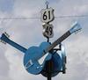 A signpost in Mississippi for state highway 61 and 49 with blue guitars