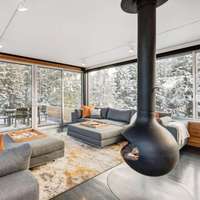 The floating modern fireplace in the living room at a Vrbo rental chalet in Winter Park, Colorado