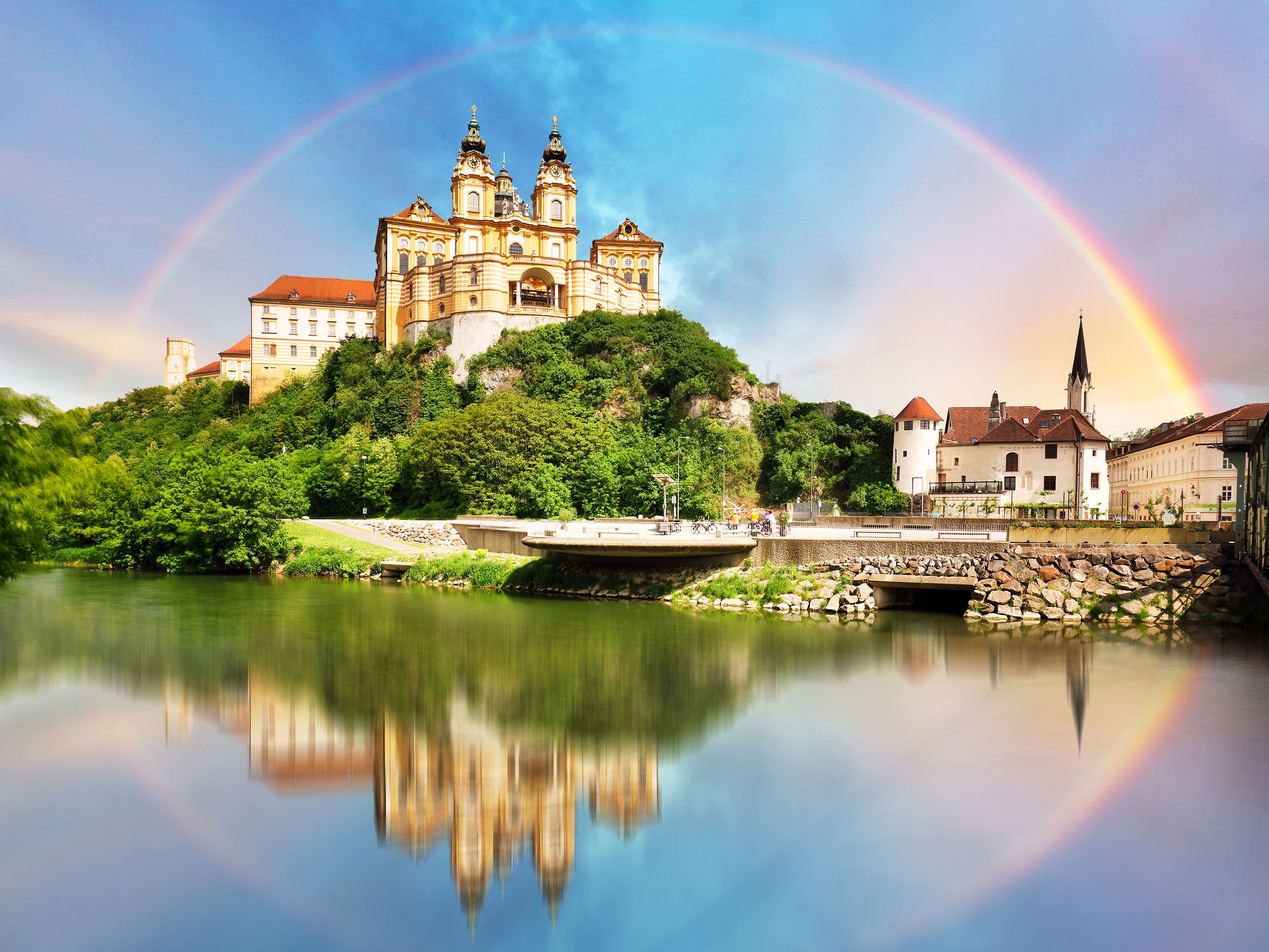 Rainbow over Melk Abbey with reflection in the Danube River in Melk, Austria