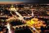 Aerial night view of an illuminated Castel Sant'Angelo and Saint Peter Basilica in Rome, Italy.