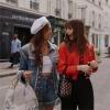 Lily Collins as Emily and Ashley Park as Mindy hitting the streets in the Netflix series Emily in Paris. Courtesy of Netflix