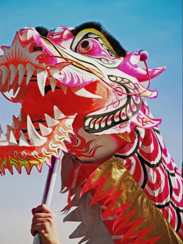 A hand holds aloft a Chinese dragon head during a Lunar New Year parade in Chicago, IL