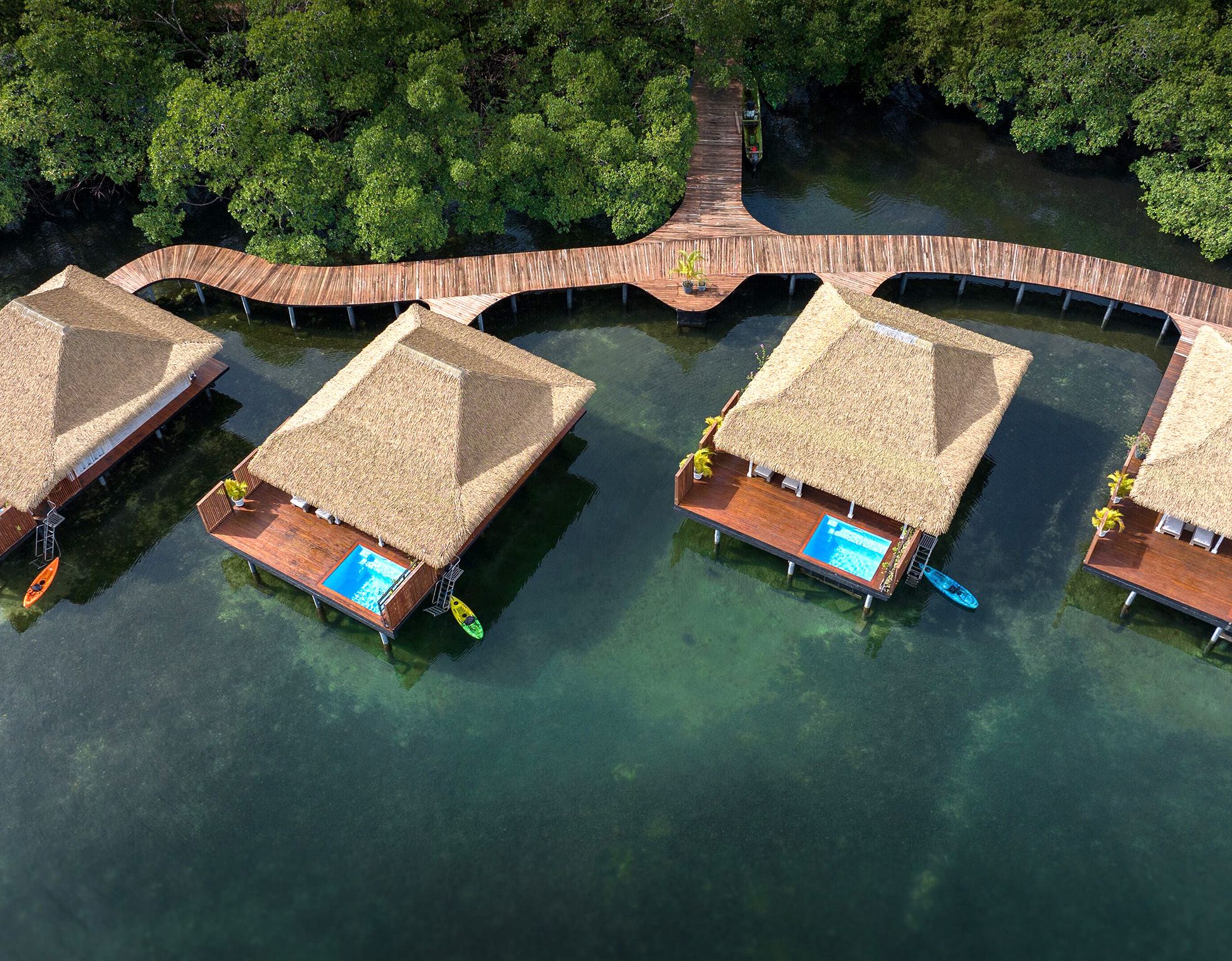 Overview photo of over-the-water bungalows with a pathway.