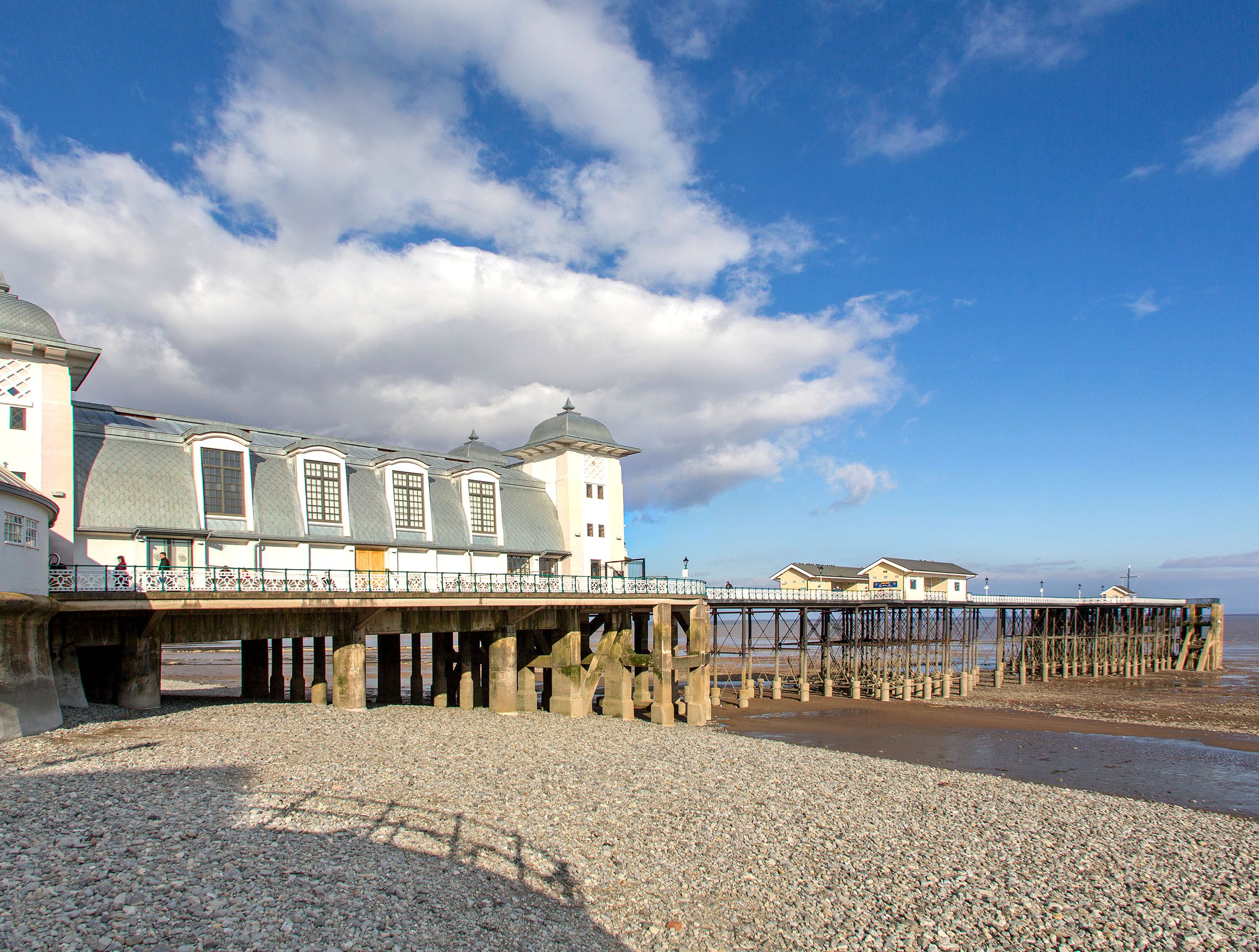 Large pier and rocky beach.