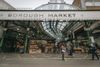 The entrance to London's Borough Market, with a vegetable stall and shoppers ready to pounce