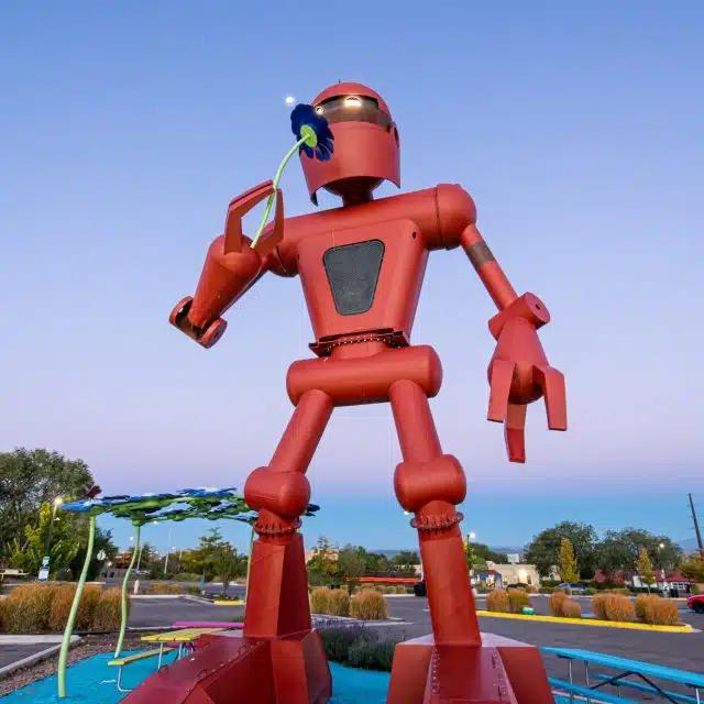 Christian Ristow’s sculpture Becoming Human is a large, red robot-like figure on display at Meow Wolf Santa Fe