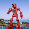 Christian Ristow’s sculpture Becoming Human is a large, red robot-like figure on display at Meow Wolf Santa Fe