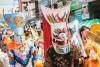 People wear colorful masks as part of the Phi Ta Khon ghost festival parade in Thailand