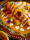 A meal of Panamanian origin is presented on a plate with a white dressing and decorated with flower petals
