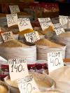 Sacks of products with prices in Cyrillic script at Osh Bazaar in Bishkek, the capital of Kyrgyzstan