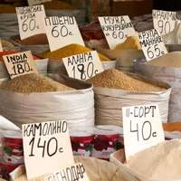 Sacks of products with prices in Cyrillic script at Osh Bazaar in Bishkek, the capital of Kyrgyzstan
