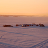 Colorful houseboats frozen into Yellowknife Bay, seen at dusk